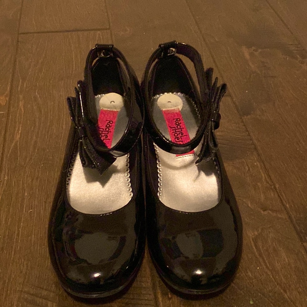 The color of these shoes are black and the brand is Rachel shoes.